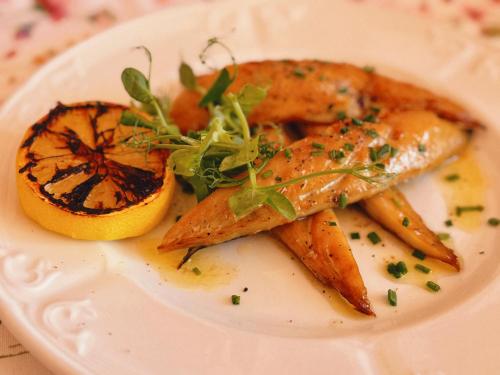 a plate of food with carrots and orange slices at The Robin Hill in Torquay