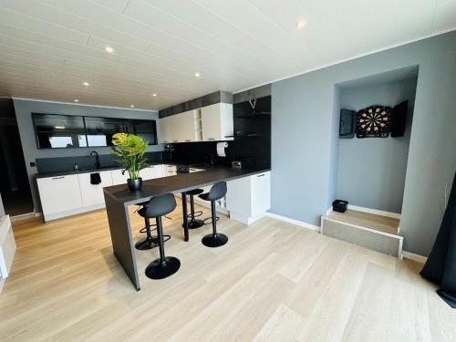 a kitchen with a table and stools in a room at Le Studio by Home Concept in Warisoulx