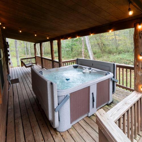 a hot tub on the deck of a cabin at Sycamore - by The Chalets in South Bloomingville
