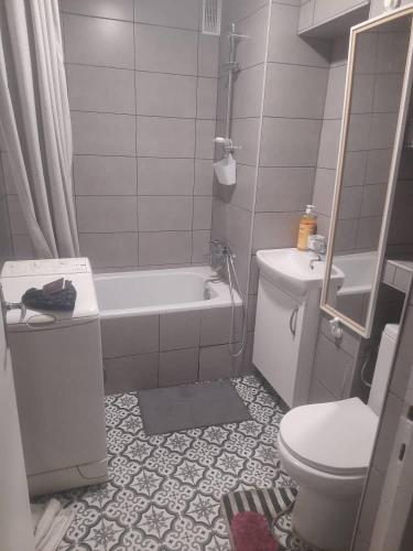 une salle de bain avec une baignoire, des toilettes et un lavabo dans l'établissement Appartement calme & proche Paris, à Bois-Colombes