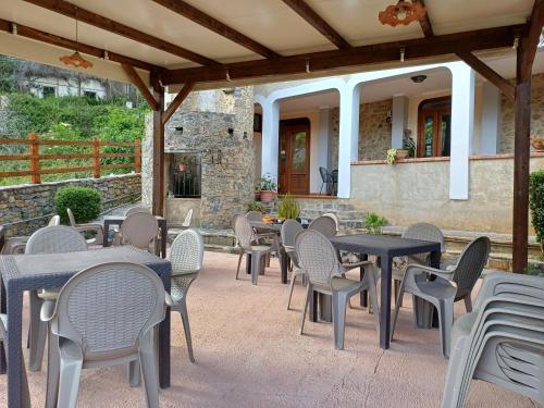 a patio with tables and chairs and a building at Country House B&B Antica Dimora Del Sole in Camerota