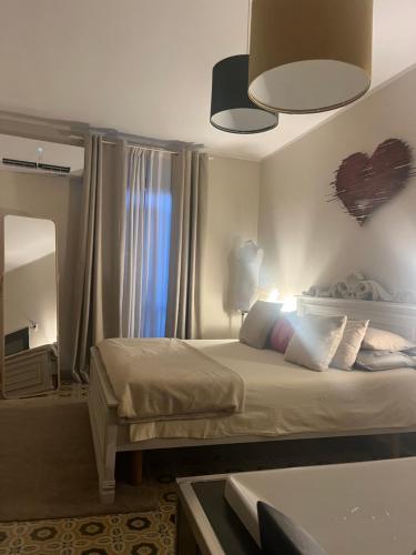a bedroom with a bed with a heart on the wall at La Corte dei Prefetti di Vico Bellavista Relax in Ronciglione
