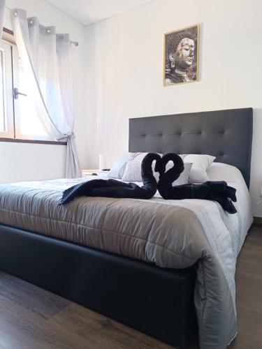 a bedroom with a bed with two swans on it at Reis Apartment in Porto