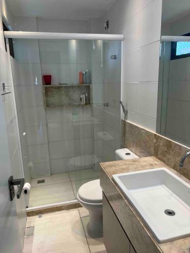 a bathroom with a shower and a toilet and a sink at Complete beach house! in Cabedelo