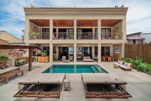 a house with a swimming pool and a patio at Barracuda Boutique in Itacaré