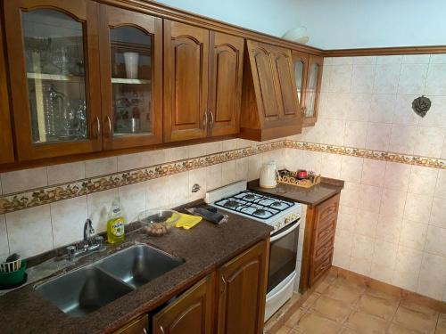 a kitchen with a sink and a stove top oven at Casa para 6 a 5 cuadras del centro in Chumillo
