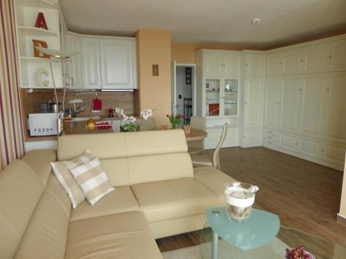 a living room and kitchen with a couch and a table at Appartement Meeresbrise in Pelzerhaken