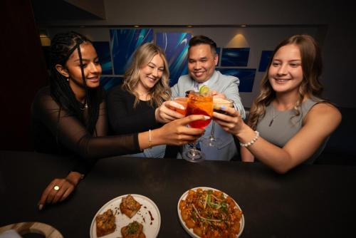 a group of people sitting at a table with drinks at Delta Hotels by Marriott Kingston Waterfront in Kingston