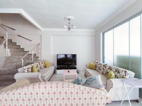 a living room with a couch and a tv at enjoy in Cesme