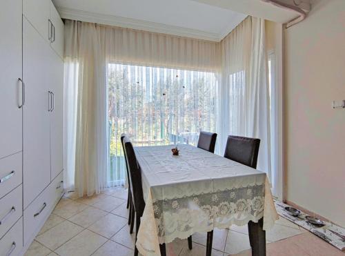 a dining room with a table and a large window at enjoy in Cesme