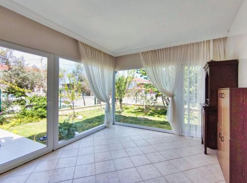 an empty living room with sliding glass doors at enjoy in Cesme