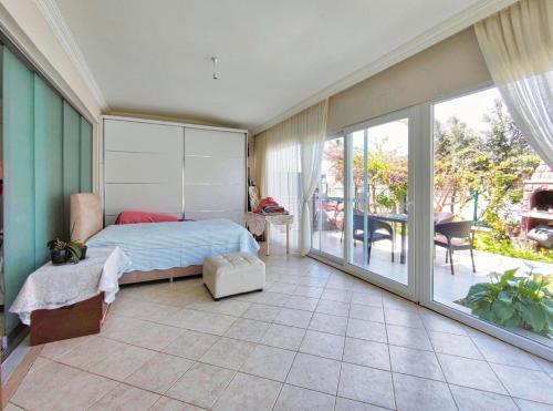 a bedroom with a bed and a balcony at enjoy in Cesme