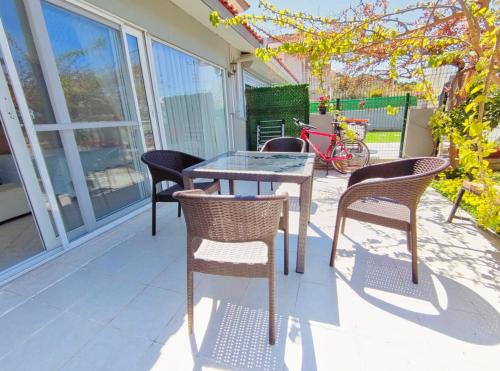 a table and chairs sitting on a porch with a table and chairs at enjoy in Cesme