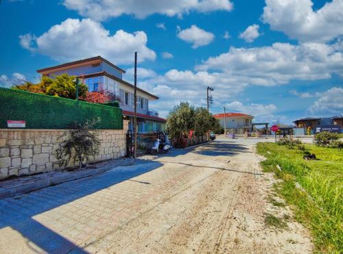 a dirt road in a town with a building at enjoy in Cesme