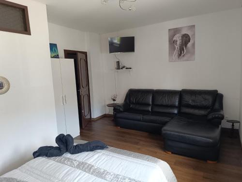 a living room with a couch and a black leather couch at Reis Apartment in Porto