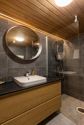 a bathroom with a sink and a mirror at Hotel Waltikka in Valkeakoski