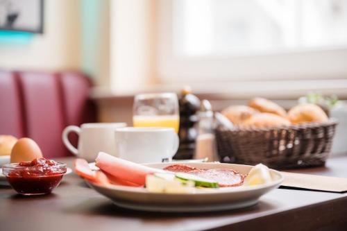a table with a plate of food and a basket of bread at Strandvilla Glückauf in Binz