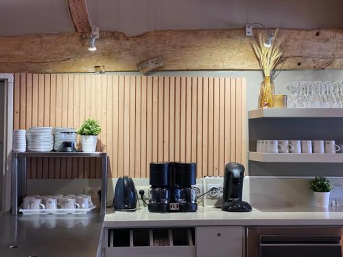 a kitchen with a coffee maker on a counter at Landgoed De Hoogmolen in Oudsbergen 
