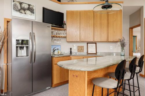 a kitchen with a stainless steel refrigerator at Lakeside Shores Escape - Adventure Awaits Peaceful Retreat Just Minutes from Traverse City in Traverse City