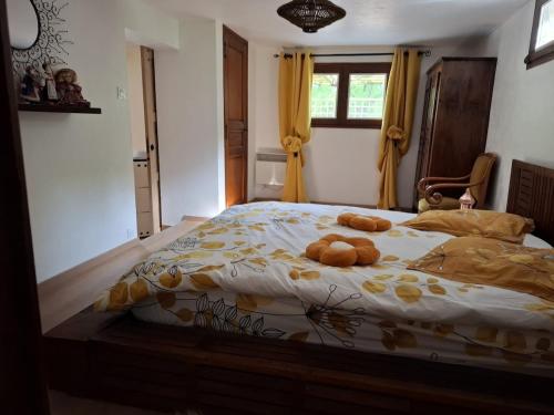 a bedroom with a bed with two teddy bears on it at Gite OLIVIRA in Vesseaux