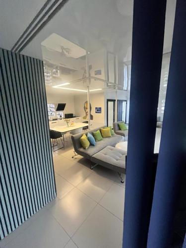a living room with a couch and a table at Dom na wodzie in Bydgoszcz