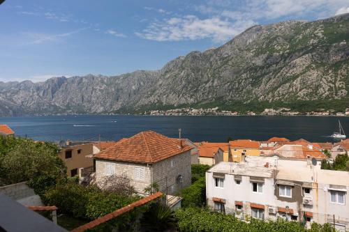 a town with a view of the water and mountains at Full Sea View Penthouse with Panoramic terrace in Prčanj