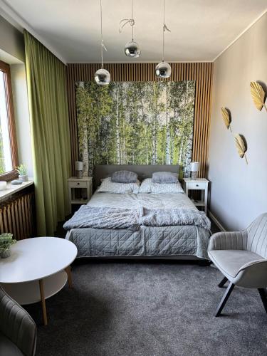 a bedroom with a bed and a large window at Apartments 52 in Biała Podlaska