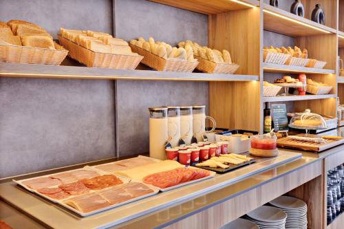 a buffet with bread and pastries and other foods at B&B HOTEL Alicante in Alicante
