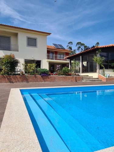 a swimming pool in front of a house at ToorgoHouse in Boticas