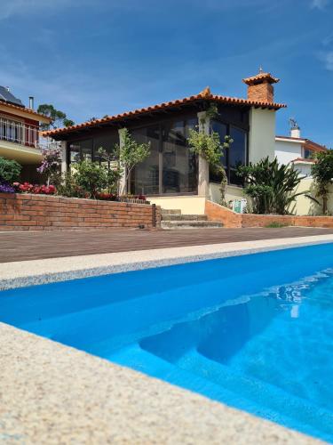 a house with a swimming pool in front of a house at ToorgoHouse in Boticas
