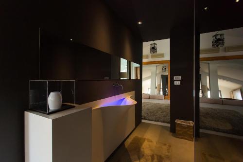 a kitchen with a counter with a vase on it at Boutique Hotel Valsabbion in Pula