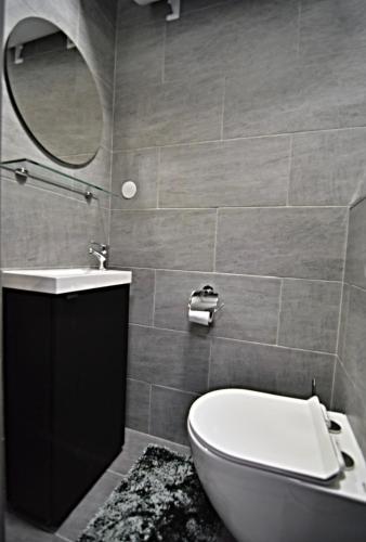 a bathroom with a toilet and a sink and a mirror at Oblivion in Velingrad