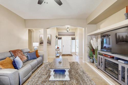 a living room with a couch and a tv at Sun City Serenity in Oro Valley