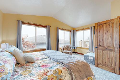 a bedroom with a large bed and a window at Salty Sunsets in Depoe Bay