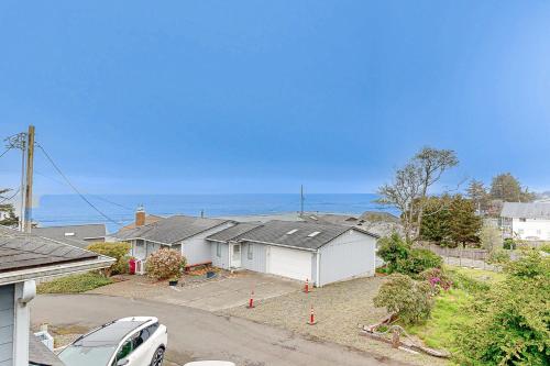 a house with a car parked in front of it at Salty Sunsets in Depoe Bay