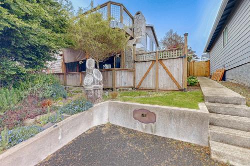 a backyard with a fence and a gate and stairs at Salty Sunsets in Depoe Bay