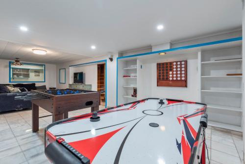 a room with a pool table and a living room at Oversized Family Beach Block Duplex with Game Room in Atlantic City