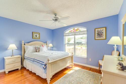 a blue bedroom with a bed and a window at Pet-Friendly Home with Golf Cart in The Villages! in Lady Lake