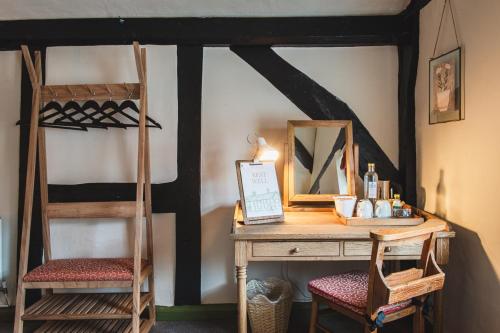 a desk with a mirror and a ladder and a bunk bed at Bel and The Dragon-Odiham in Odiham