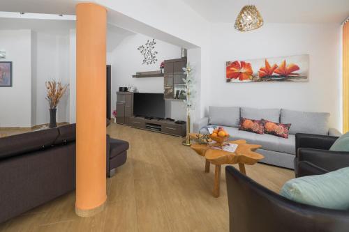 a living room with a couch and a table at Villa Brcina in Pula