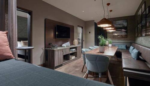 a bedroom with a bed and a dining room at Downtown Camper by Scandic in Stockholm