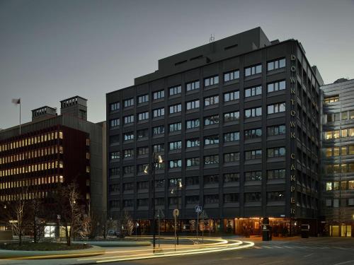 a large black building with a street in front of it at Downtown Camper by Scandic in Stockholm