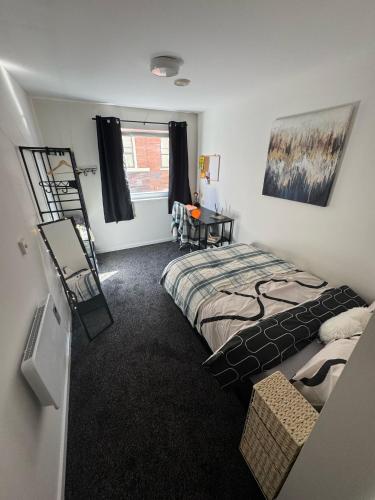 a room with two beds and a desk in it at 248 Halls in Middlesbrough