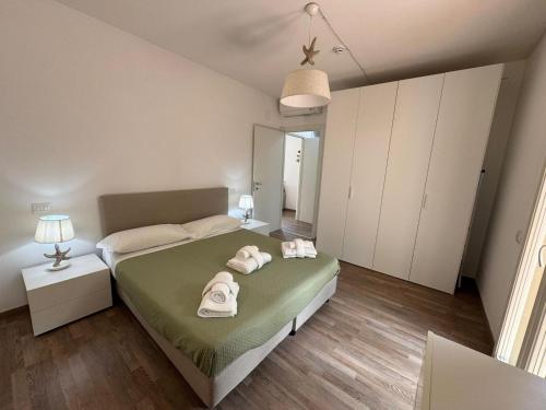 a bedroom with a bed with towels on it at Residence San Francesco in Tirrenia