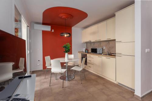 a kitchen with a table and white cabinets at Full Sea View Penthouse with Panoramic terrace in Prčanj