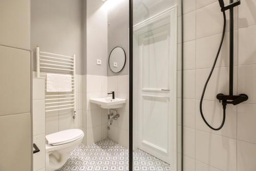 a bathroom with a toilet and a sink and a shower at High Note Suites in Belgrade