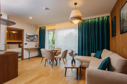 a living room with a couch and a table at Forest Park Resort & SPA in Świeradów-Zdrój