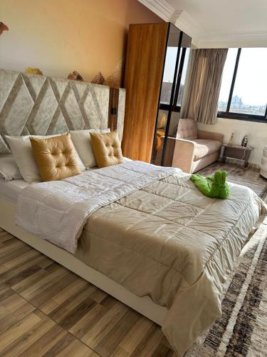 a bedroom with a large bed in a room at Luxury Panorama pyramids & jacuzzi in Cairo