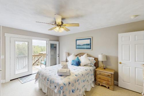 a bedroom with a bed and a ceiling fan at Wet Feet Retreat in Moneta