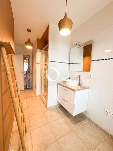 a bathroom with a sink and a mirror at COC - Au Vent Du Kent in Wissant